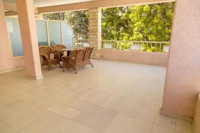 a patio with chairs and a table on a balcony at Chrysanthos Boutique Apartments in Limassol