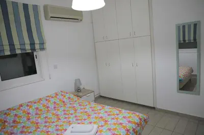 a bedroom with a bed with a colorful blanket at Bianco E U Apartment in Nicosia