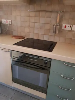 a kitchen with a stove and a counter top at Bianco E U Apartment in Nicosia