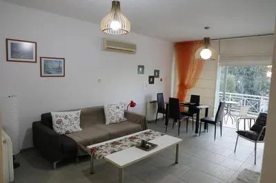 a living room with a couch and a table at Bianco E U Apartment in Nicosia