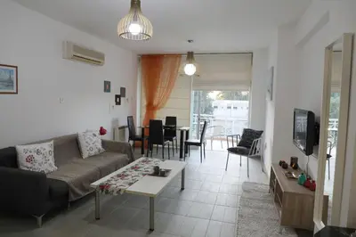 a living room with a couch and a table at Bianco E U Apartment in Nicosia