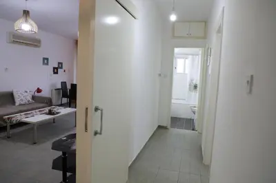 a living room with a couch and a table in a room at Bianco E U Apartment in Nicosia