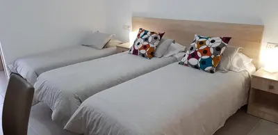 two beds sitting next to each other in a room at Sunny Napa Apartments in Ayia Napa