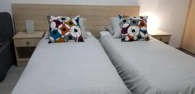 two beds sitting next to each other in a room at Sunny Napa Apartments in Ayia Napa