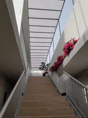 a stairway in a building with pink flowers at Sunny Napa Apartments in Ayia Napa