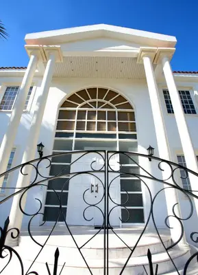 a white house with a gate in front of it at The White House in Larnaka