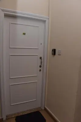 a white door in a room with a door sidx sidx at Kolonaki Seaview Apartments in Larnaka