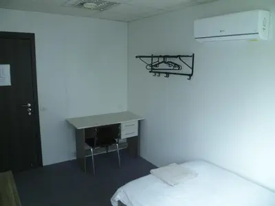 a room with a desk and a bed and a desk and a deskictericter at Datacom Guest House in Nicosia