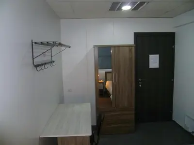 a room with a desk and a basketball hoop on the wall at Datacom Guest House in Nicosia