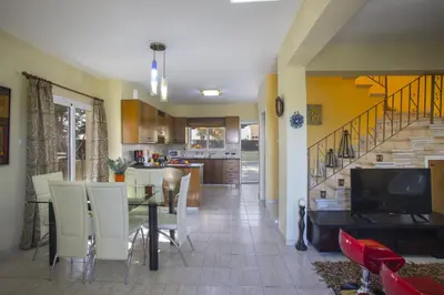 a kitchen and dining room with a table and chairs at Ayia Napa Tropical Beach Villa in Ayia Napa