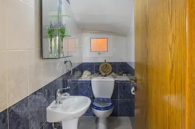 a bathroom with a toilet and a sink at Ayia Napa Tropical Beach Villa in Ayia Napa