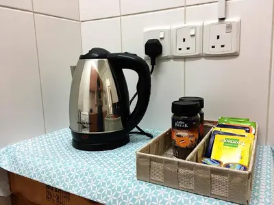 a toaster sitting on top of a counter next to a table at Comfortable Engomi Apartment in Yukarı Lakatamya