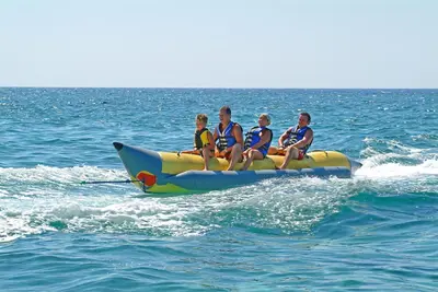 a group of people sitting on a raft in the water at Okeanos Beach Boutique Hotel in Ayia Napa