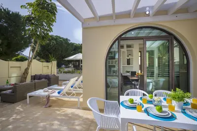 a patio with a white table and chairs at Villa Mylos 8 in Protaras