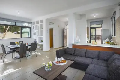 a living room with a couch and a table at Villa Mylos 8 in Protaras
