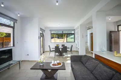 a living room with a couch and a table at Villa Mylos 8 in Protaras