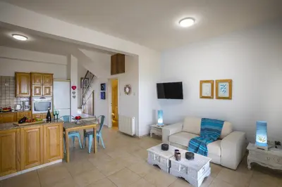 a living room with a couch and a table at Meneou Beachfront Villa in Meneou