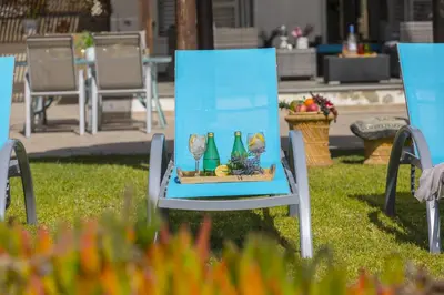a blue chair in the grass with vases on it at Meneou Beachfront Villa in Meneou