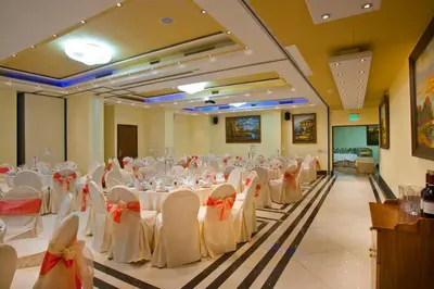 a banquet hall with white tables and chairs in a room at Semeli Hotel in Nicosia