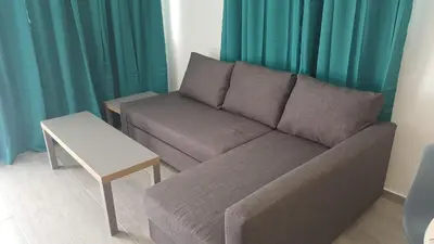 a living room with a couch and a table at Manoli Apartments in Ayia Napa