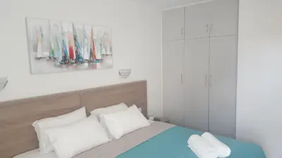 a bedroom with a bed and a painting on the wall at Manoli Apartments in Ayia Napa