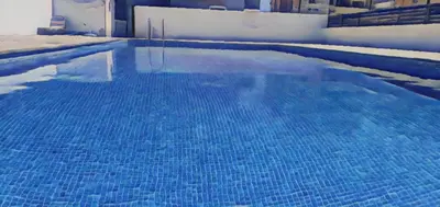 a large blue swimming pool with blue water at Vasilas Holiday Apartment #1 in Larnaka