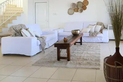 a living room with white couches and a coffee table at Phaedrus Living: Seaside Luxury Villa Anafi in Paralimni