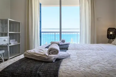 a bedroom with a bed with towels and a window at Phaedrus Living: Seaside Luxury Villa Anafi in Paralimni