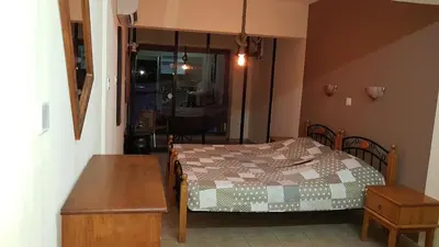 a small bedroom with a bed and a table at Pomelo Apartments in Ayia Napa