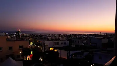 a view of a city at sunset at Pomelo Apartments in Ayia Napa