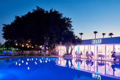 a hotel with a swimming pool in front of a building at So White Beach Resort in Ayia Napa