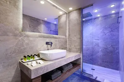 a bathroom with a sink and a shower at So White Beach Resort in Ayia Napa