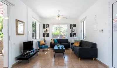 a living room with two couches and a tv at Villa Willow Mandali by Ezoria Villas in Protaras