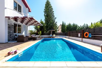 a swimming pool in the backyard of a house at Villa Willow Mandali by Ezoria Villas in Protaras
