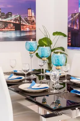 a table with wine glasses and plates on it at Villa Willow Mandali by Ezoria Villas in Protaras