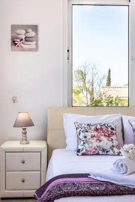 a bedroom with a white bed and a window at Villa Willow Mandali by Ezoria Villas in Protaras
