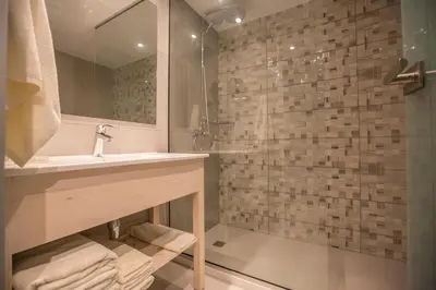 a bathroom with a sink and a shower at Stratovarius Nissi Rooms in Ayia Napa