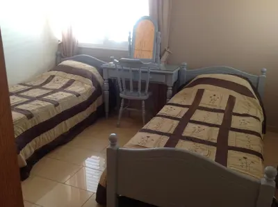 two beds in a room with a table and a chair at Villa Garmar CTO Approved 4487 in Paralimni