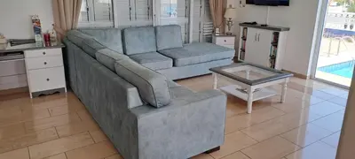 a living room with a blue couch and a table at Villa Garmar CTO Approved 4487 in Paralimni