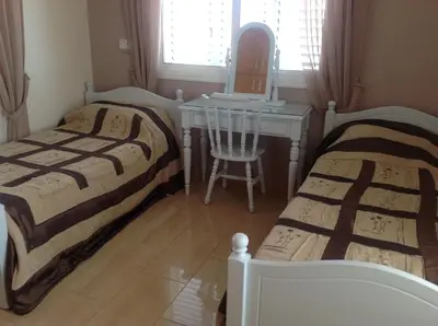 two beds in a room with a table and a chair at Villa Garmar CTO Approved 4487 in Paralimni