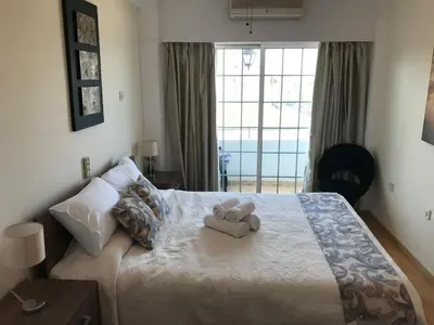 a bedroom with a bed with two stuffed animals on it at Beach Haven in Larnaka
