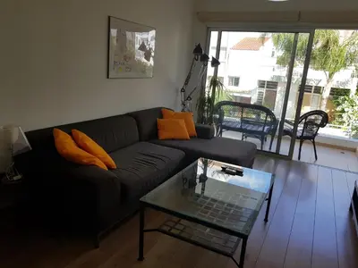 a living room with a couch and a glass table at Achillion Gardens, near UNIC By 'Flats Nicosia' in Nicosia