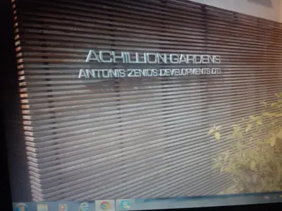 a view of a window with a garage door with a sign at Achillion Gardens, near UNIC By 'Flats Nicosia' in Nicosia