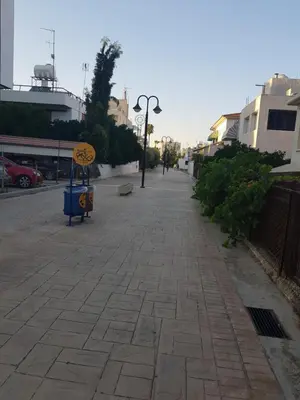 an empty street with a sign on the sidewalk at Achillion Gardens, near UNIC By 'Flats Nicosia' in Nicosia