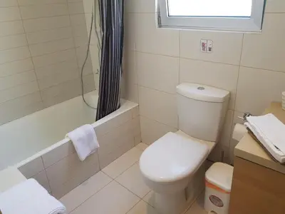 a bathroom with a toilet and a shower and a sink at Achillion Gardens, near UNIC By 'Flats Nicosia' in Nicosia