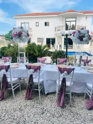 a table with purple and white flowers on it at Larnaca Mansion Ideal for 3 Families or more in Larnaka