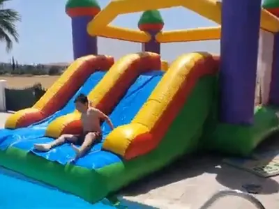 a young boy playing on a inflatable antidepressricularricularricularricularricularricularricular at Larnaca Mansion Ideal for 3 Families or more in Larnaka