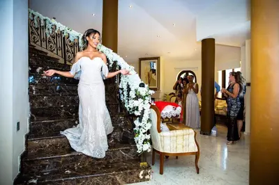 a bride walking down the stairs at her wedding at Larnaca Mansion Ideal for 3 Families or more in Larnaka