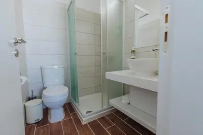 a bathroom with a toilet and a shower and a sink at River View Boutique Apts in Ayia Napa
