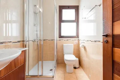 a bathroom with a toilet and a shower and a sink at Sea Front Oceanus H2 by Ezoria Villas in Ayia Napa